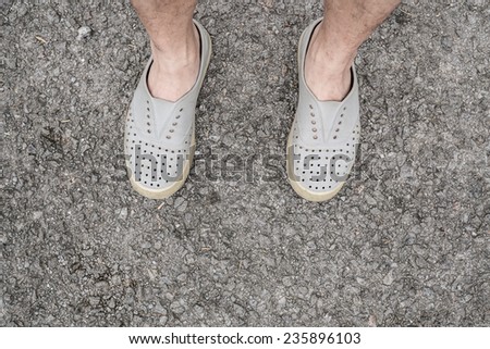 rubber shoes and leg on the ground