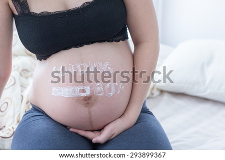 pregnant woman with painted on white paints cream - loading and figures 80% idea of creativity in the stage of uterine development, looking forward to long awaited child