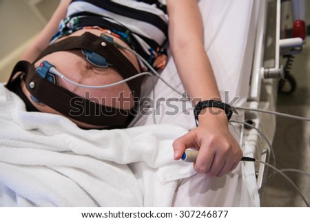 Pregnant woman with Electrocardiograph check up for her baby. hand pushing nurse call button