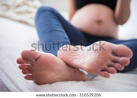 Close up feet of women on the bed
