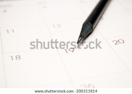 Close-up of a pen on a schedule planner