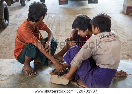 MYAWADDY MYANMAR - SEP26 : Workers truck playing smart phones at Myawaddy Trade zone import inspection, Karen state, Myanmar on SEPTEMBER26, 2015