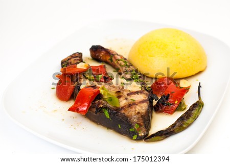 salmon food with grilled vegetables and polenta on white plate