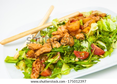 chicken salad with vetables and sauce on white sauce