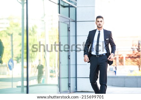 elegant handsome business man walking on the street