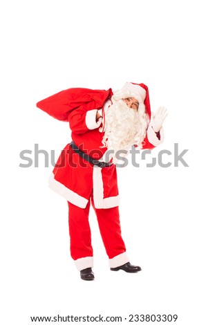 santa claus waving and holding his sack of gifts on the back