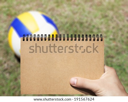 craft horizontal blank notebook in man hand and ball background