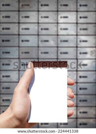 white blank vertical notebook in woman hand and bank background