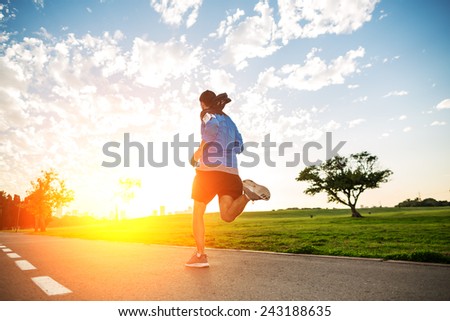 sportsman running in the park in sunset