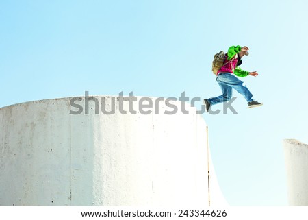 brave man jumping over the concrete wall