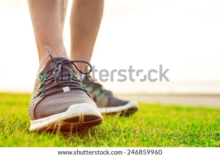sportsman\'s legs in running shoes close up