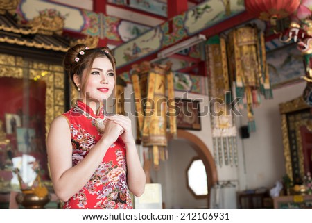 Smiling Chinese woman dress traditional cheongsam at New Year