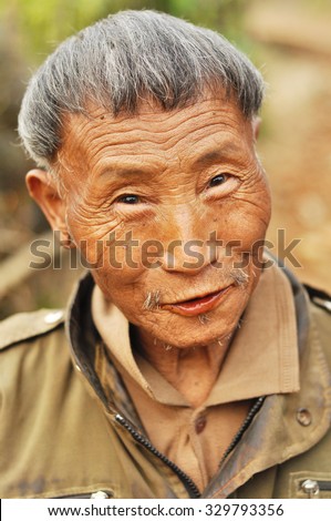 Nagaland, India - March 2012: Portrait of an old man smiling at camera in Nagaland, India. Documentary editorial.