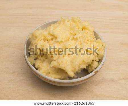 The wiped cheese and crushed garlic on a saucer