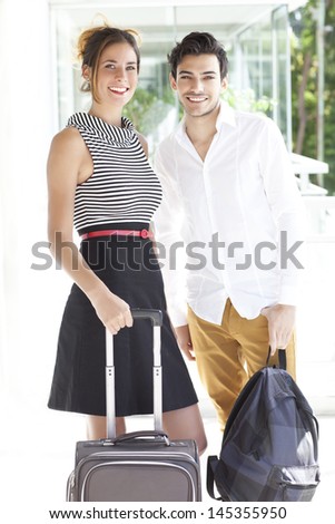boyfriend and girlfriend with suitcase and backpack