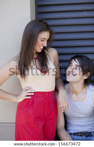 girl and boy smiling and looking each other
