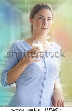 woman drinking milk in a balcony