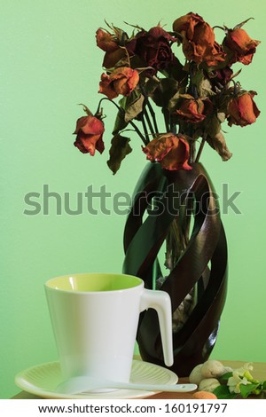 Coffee cup and rose vase on table for take a break and relax time