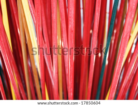 A splaying set of straw-like red abstract shapes