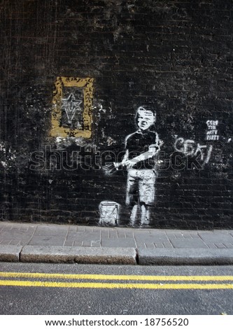 graffiti of a boy with a paint brush and  a frame in londons east end