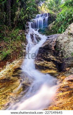 Beautiful silky waterfall flow through stones, Huay Kaew Waterfall, Chiang mai Province, Thailand.