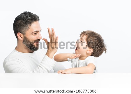 Give me high five, father and son looking happy