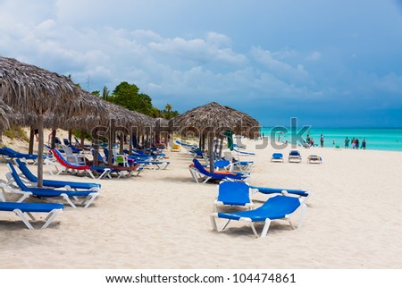 VARADERO,CUBA-MAY 26:Group of  tourists relaxing at the beach May 26,2012 in Varadero.With over a million visitors per year,Varadero is the main destination for the growing cuban tourism industry