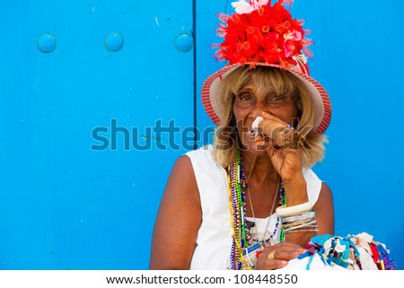 HAVANA-JULY 20:Unidentified old lady smokes a fine Cuban cigar July 20,2012 in Havana.The African culture have a huge influence in Cuba where approximately 50% of the population is of African descent