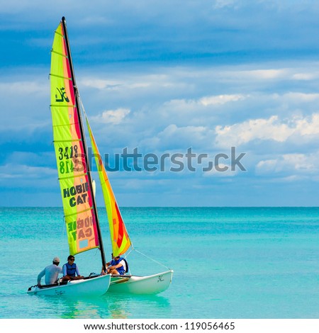 VARADERO,CUBA-NOVEMBER 3:Young couple sailing on a catamaran November 3,2012 in Varadero.With over a million visitors per year,Varadero is the destination of 40% of tourists visiting the island