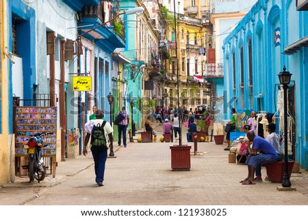 HAVANA-DECEMBER 14:Street scene with cuban people and colorful old buildings December 14,2012 in Havana.Founded in 1515,Havana is the largest city in the Caribbean with 2.4 million inhabitants
