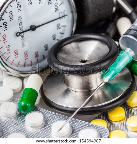 Syringe, different pills, stethoscope and sphygmomanometer useful to illustrate any medical subject