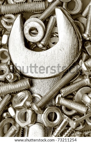 Monochromatic macro shot of a spanner, nuts and bolts useful as a background