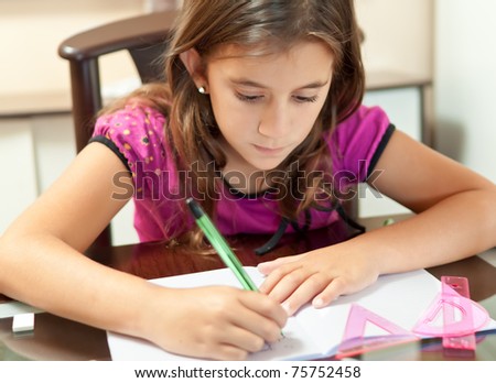 Small girl working on her school project at home