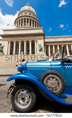 HAVANA-MAY 3: An Old Ford sits in front of the capital building on May 3, 2011 in Havana, Cuba. Cubans keep thousands of classic cars like this running despite their age & lack of parts. They\'ve become an world known icon of the country.