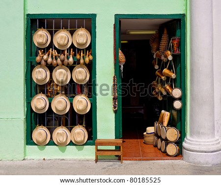 Facade of an old house selling hats, musical instruments,religious necklaces and other traditional craft in Havana