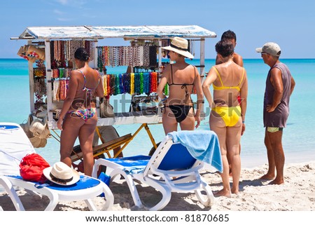 VARADERO,CUBA-JULY 16:Tourists buying souvenirs July 16,2011 in Varadero.With over a million visitors per year,Varadero is most important destination for the growing cuban tourist industry