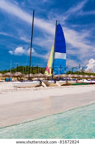 Catamaran, water bikes and thatched umbrellas in the beautiful beach of Varadero in Cuba