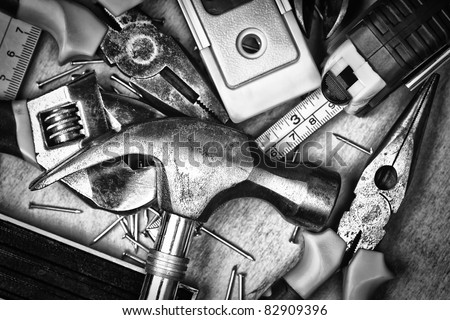 stock-photo-set-of-tools-over-a-wood-panel-on-black-and-white-82909396.jpg