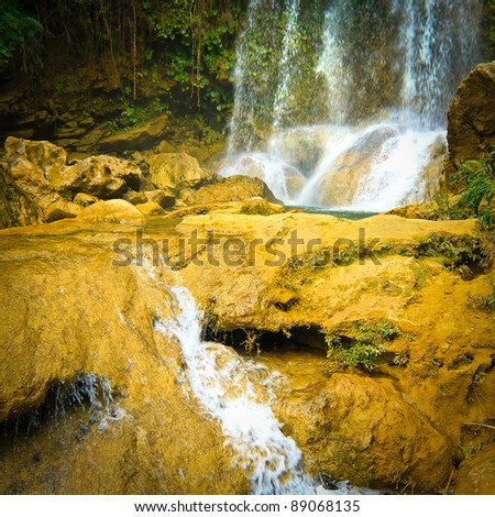 Waterfall and river flowing among rocks in the cuban natural landmark of Soroa
