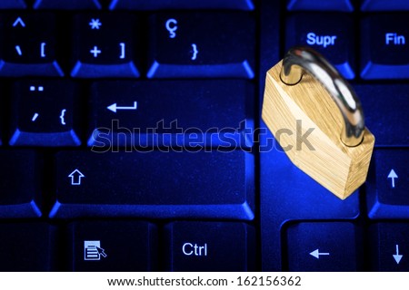 Locked padlock on a black computer keyboard with a glowing blue lightning