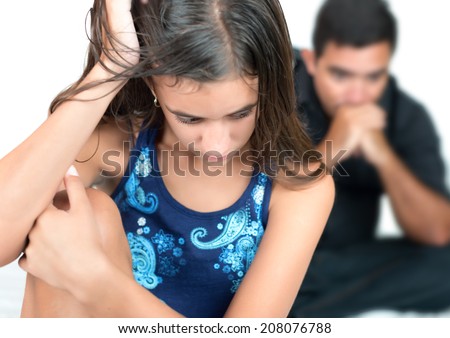 Troubled teenage girl with her worried father at home