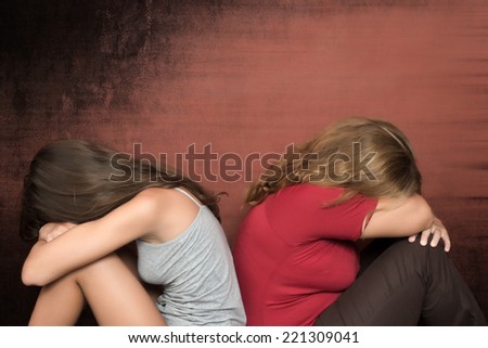 Teenager family conflict - Daughter and mother sitting on the floor crying