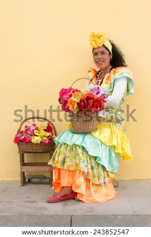 HAVANA, CUBA - JANUARY 8, 2015 : Young latin woman wearing a traditional dress in Old Havana