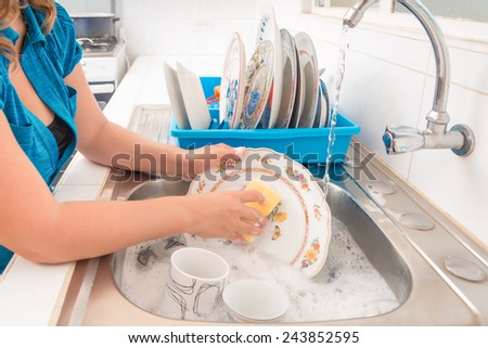 Domestic chores - Washing the dishes in the kitchen sink
