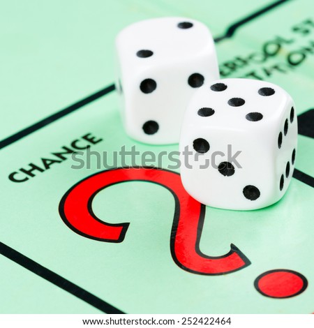 LONDON,UK - FEBRUARY 11, 2015 : Pair of dice next to the CHANCE card drawing space in a Monopoly game board