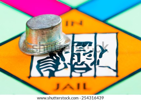 LONDON,UK - FEBRUARY 11, 2015 : Hat token next to the JAIL space in a Monopoly game board