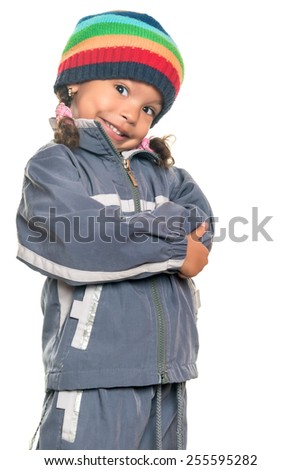 Funny mixed race little girl wearing a colorful beanie hat and a jacket with an attitude isolated on white