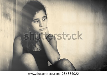 Monochrome portrait of a sad and lonely girl (with space for text)
