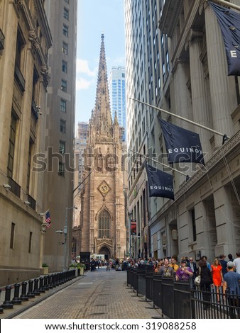 NEW YORK,USA - AUGUST 13,2015 : Wall Street and Trinity Church at the Financial District in New York City