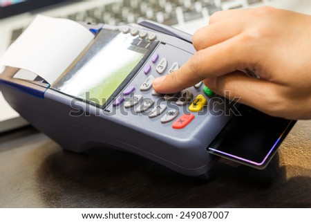 Hand Swiping Credit Card In Store